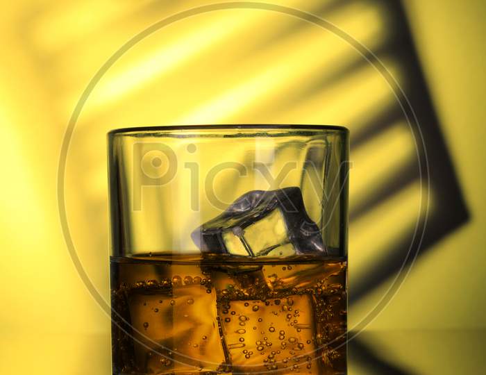 Chilled Whiskey Glass With Fizzy Soda And Ice Cubes