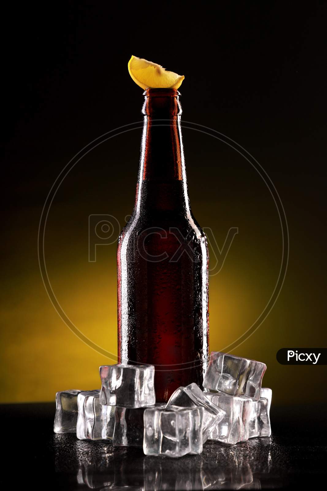 Chilled Beer Bottle With Ice Cubes And Lemon