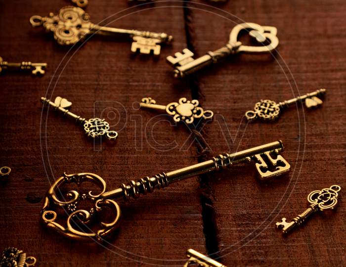 Group Of Golden Antique Keys On An Old Wood Background