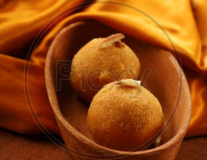 Indian Sweet Dessert Made With Gram Flour On Golden Satin And Wood