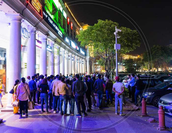 Huge Crowd Gathered Watching A Performance, Accident, Problem On The Inner Circle Of Connaught Place While The Bright Lights Of Shops Are Around Them