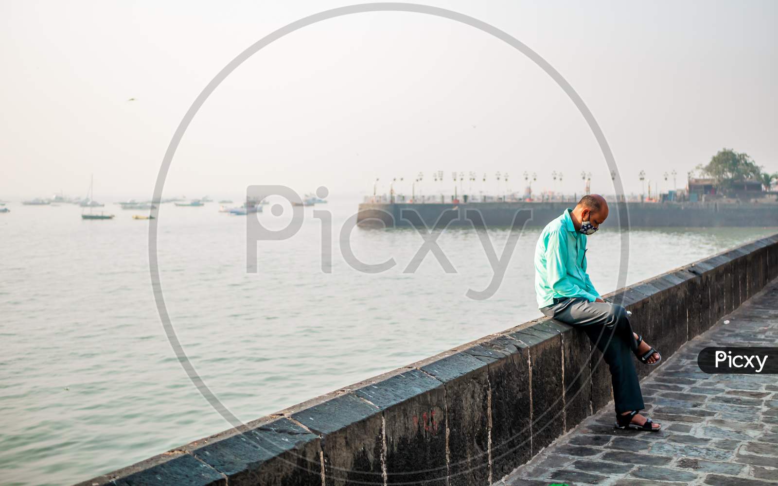 Unidentified Man Wearing A Face Mask Relating To Covid-19/Coronavirus Outbreak Near The Gateway Of India, A Famous Tourist Place In Mumbai