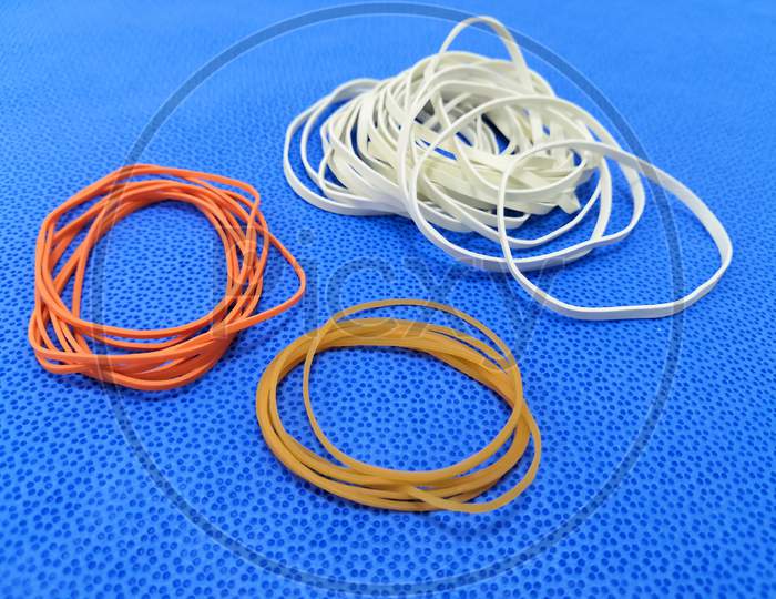 Different Color Rubber Bands In Blue Background