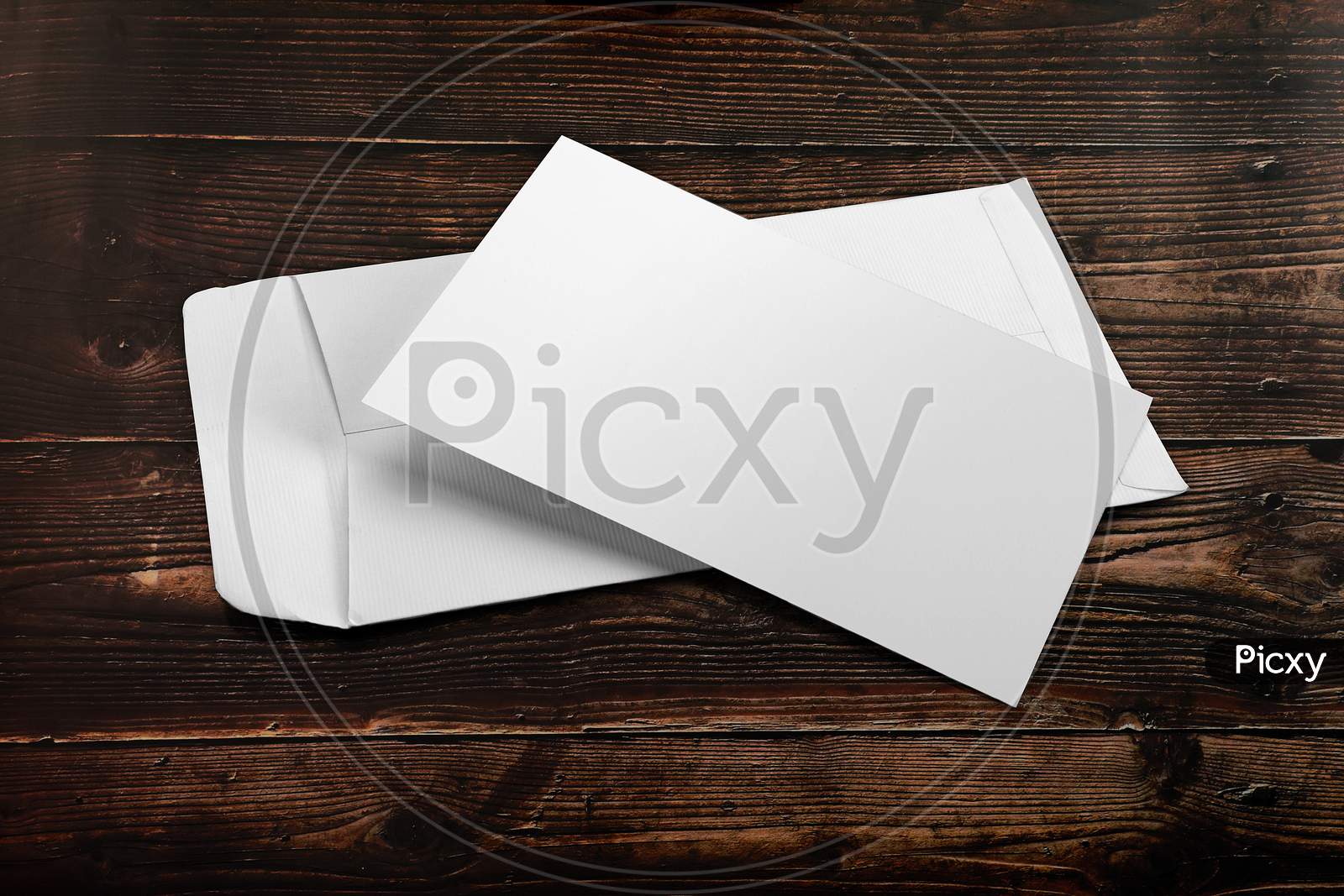 Blank White Envelope Mockup With An Invitation Card On Wooden Background