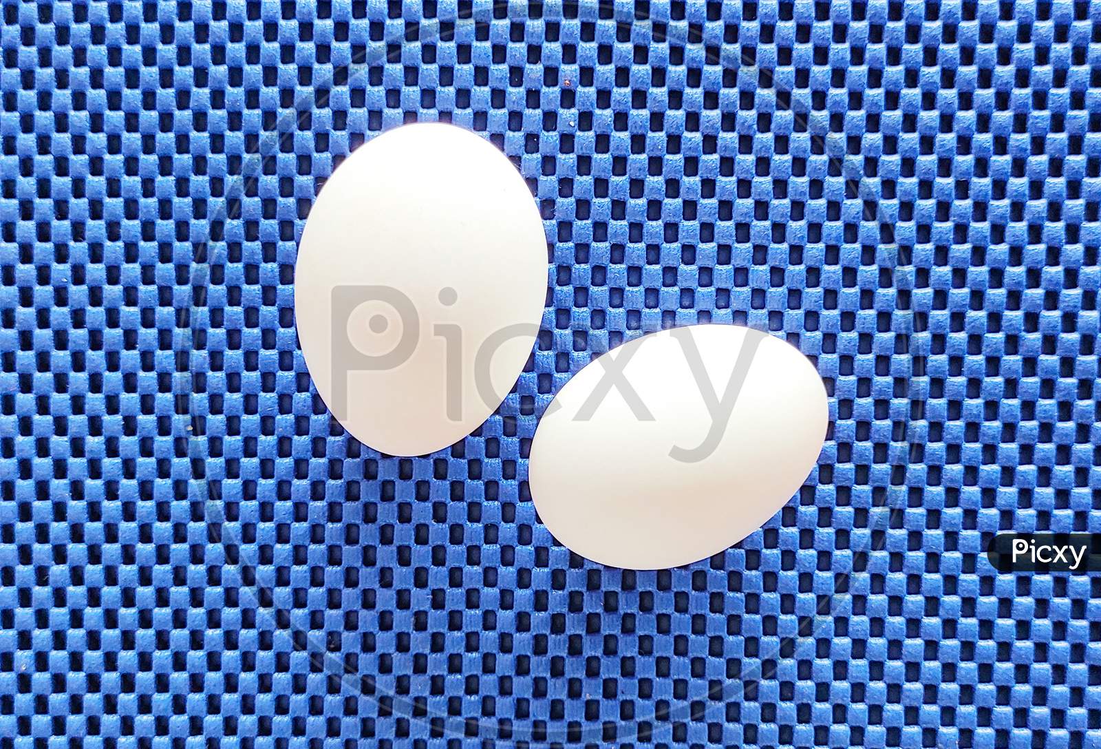 Two Eggs On Top Of A Mat