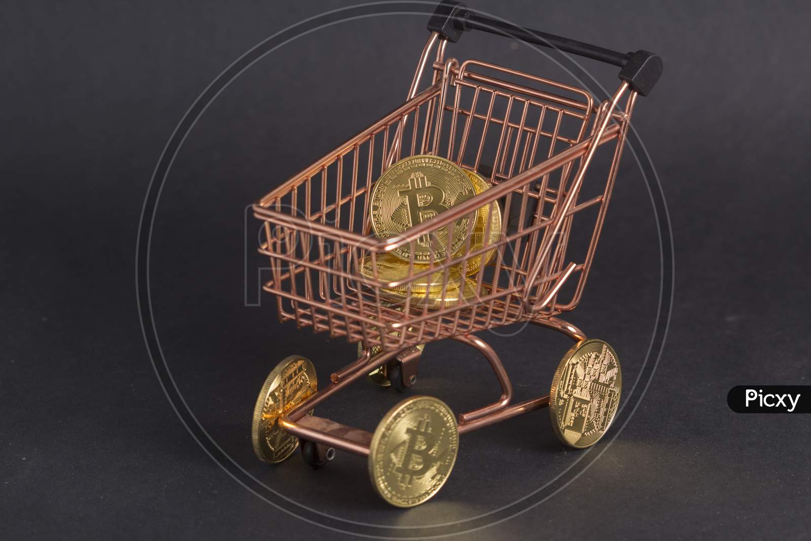 Bitcoins In Copper Shopping Cart. Black Background Stock Photo