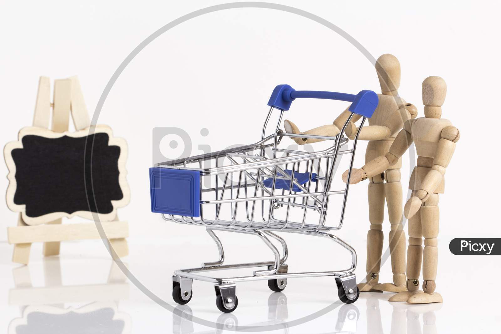 Empty Shopping Cart With Wooden Mannequin Stock Photo