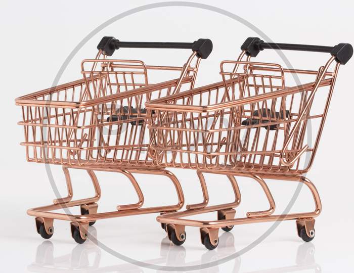 Empty Copper Shopping Basket On Colorful Background. Shop Trolley At Supermarket. Sale, Discount, Shopaholism, Black Friday, Economy Concept. Consumer Society Trend. Sustainable Lives. Stock Photo