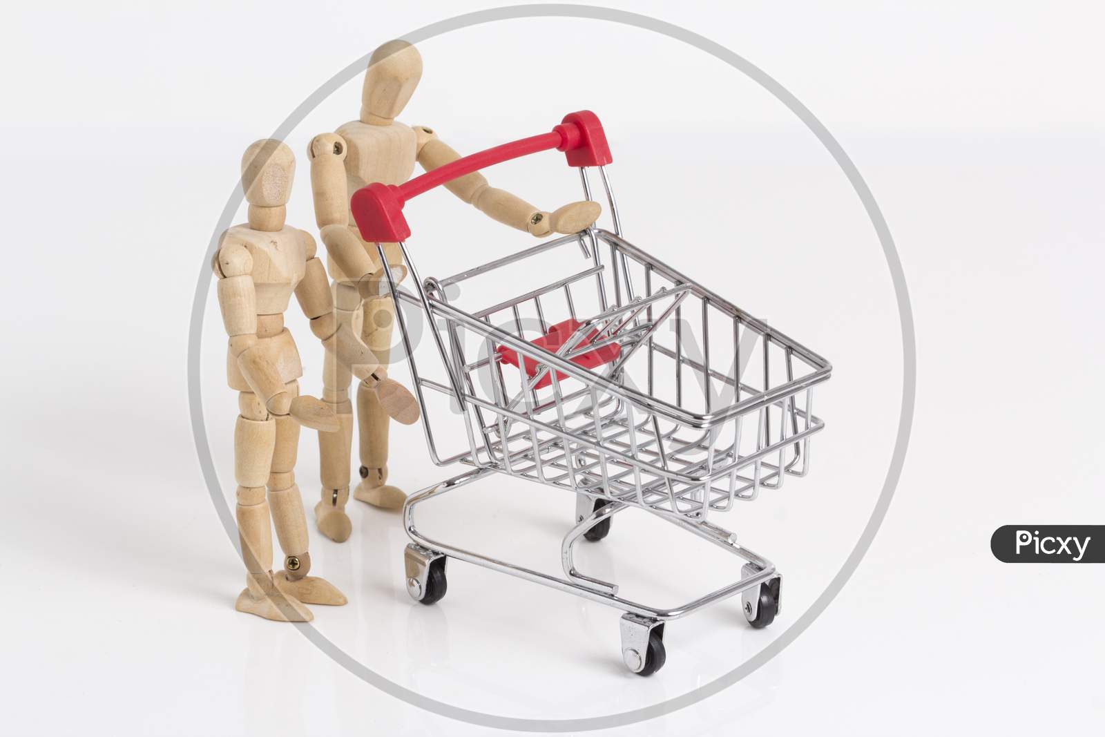 Empty Shopping Cart With Wooden Mannequin Stock Photo