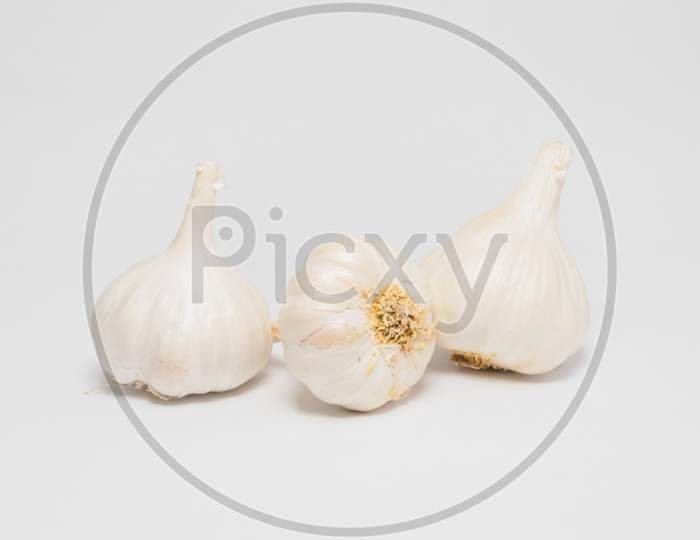 Garlic Bulbs On White Background And Selective Focus.