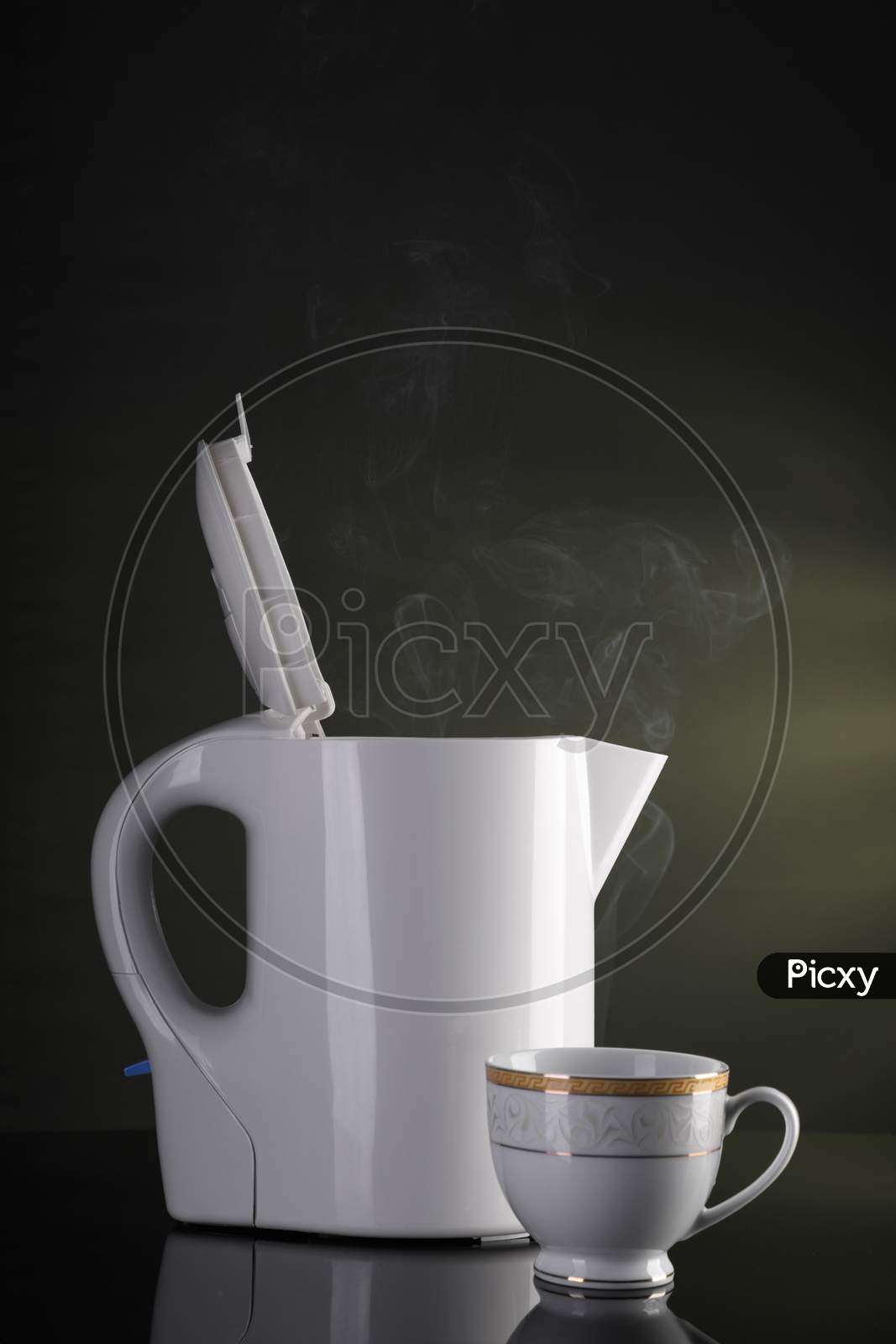 Tea Cup And Electric Kettle With Steam