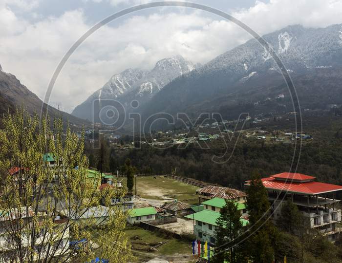 Beautiful Lachung Village Of North Sikkim, India With Snow Capped Mountains In Background