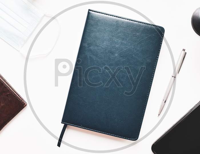 Flat Lay Journalism Travel Blogger Concept. Notebook, Pen, Phone, Facial Mask And Passport On White Background Cover Banner