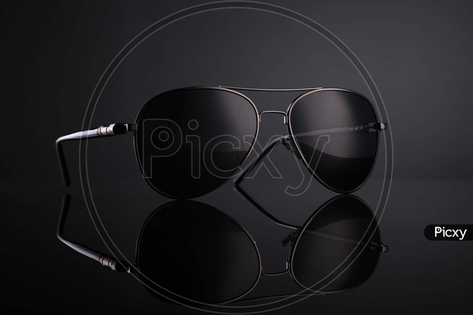 Black Aviator Sunglasses On Black Background With Reflection