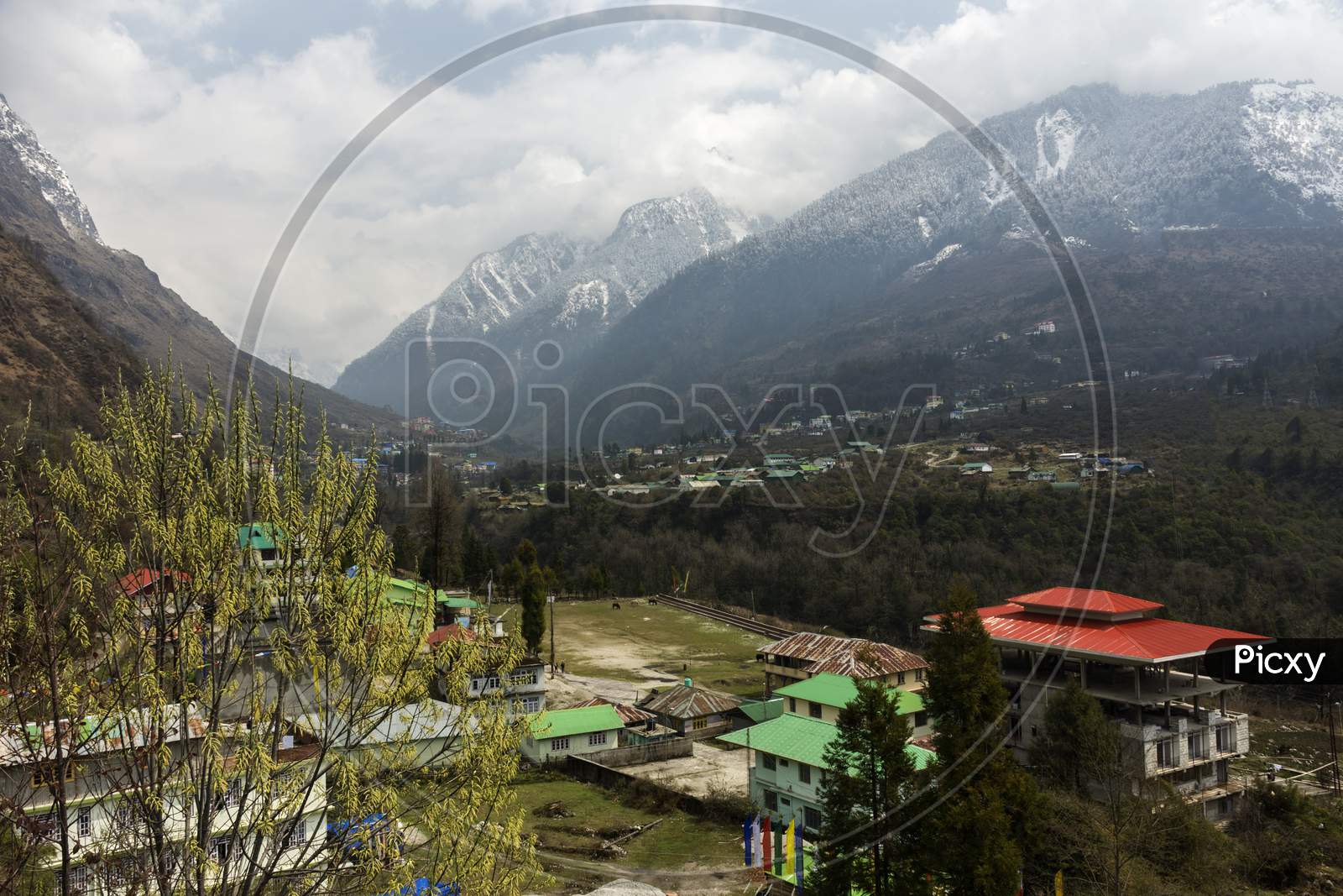 Beautiful Lachung Village Of North Sikkim, India With Snow Capped Mountains In Background