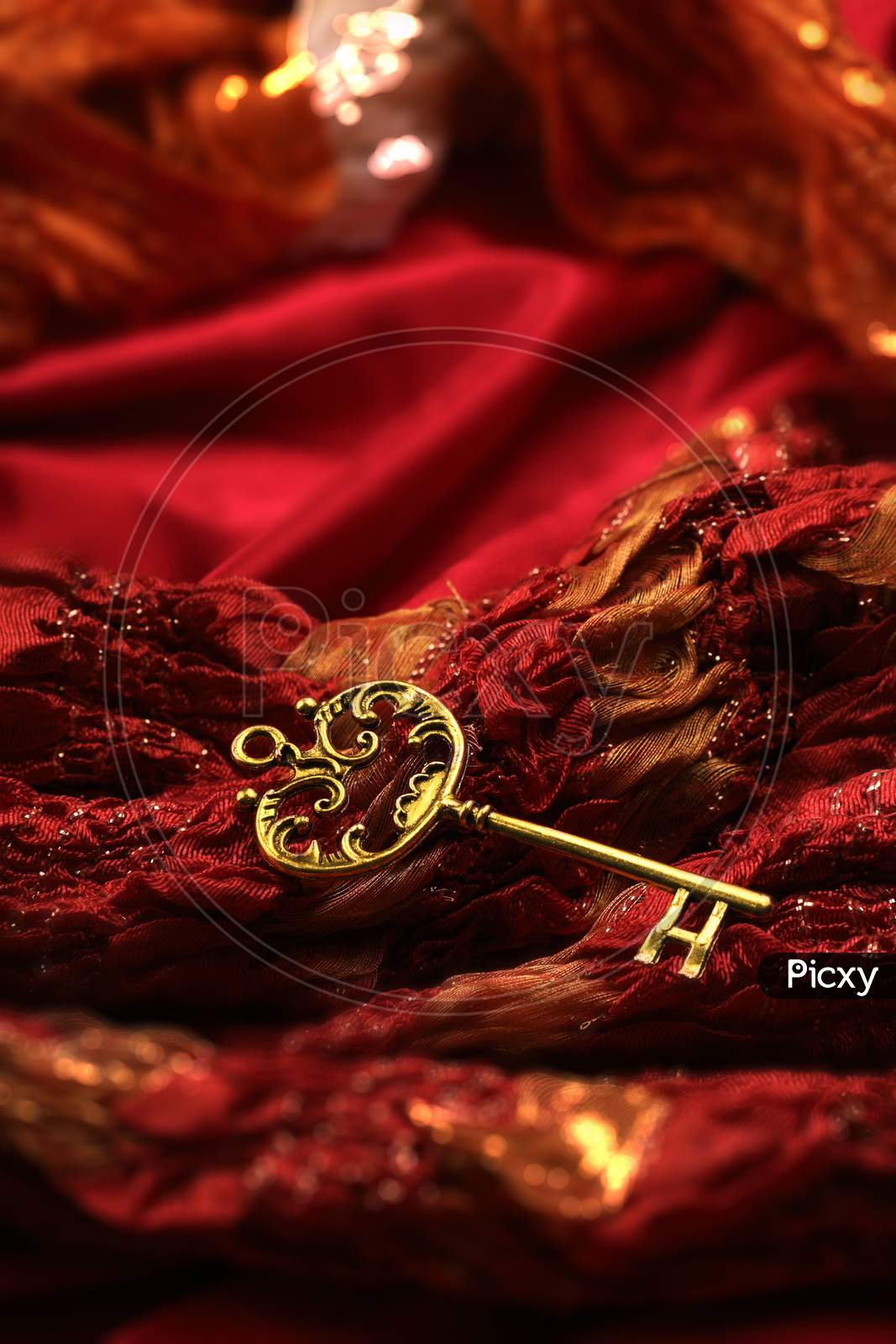 Image of Antique Golden Key On Red Fabric Background-ZZ743027-Picxy