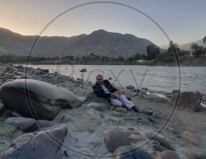 Kunar province Afganistan  a man at kunar River At Ramadan monthe near River