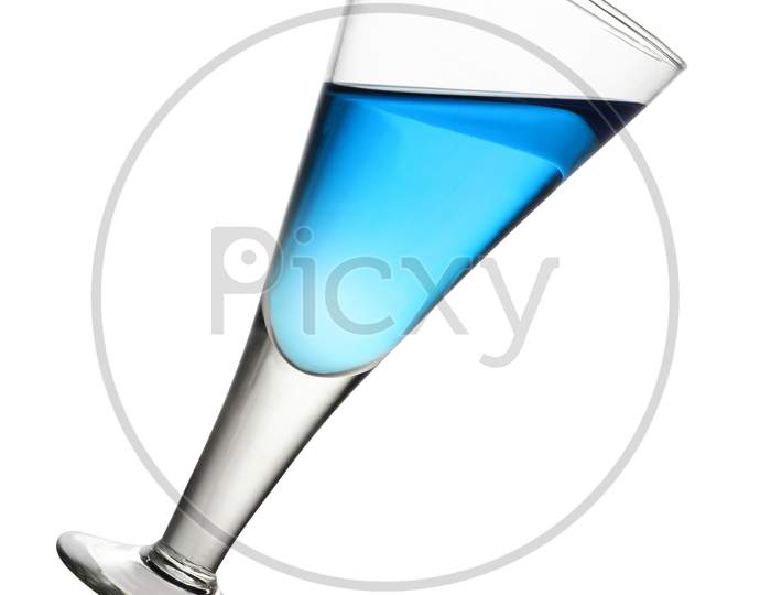 Tilted Wine Glass With Blue Drink On White Background