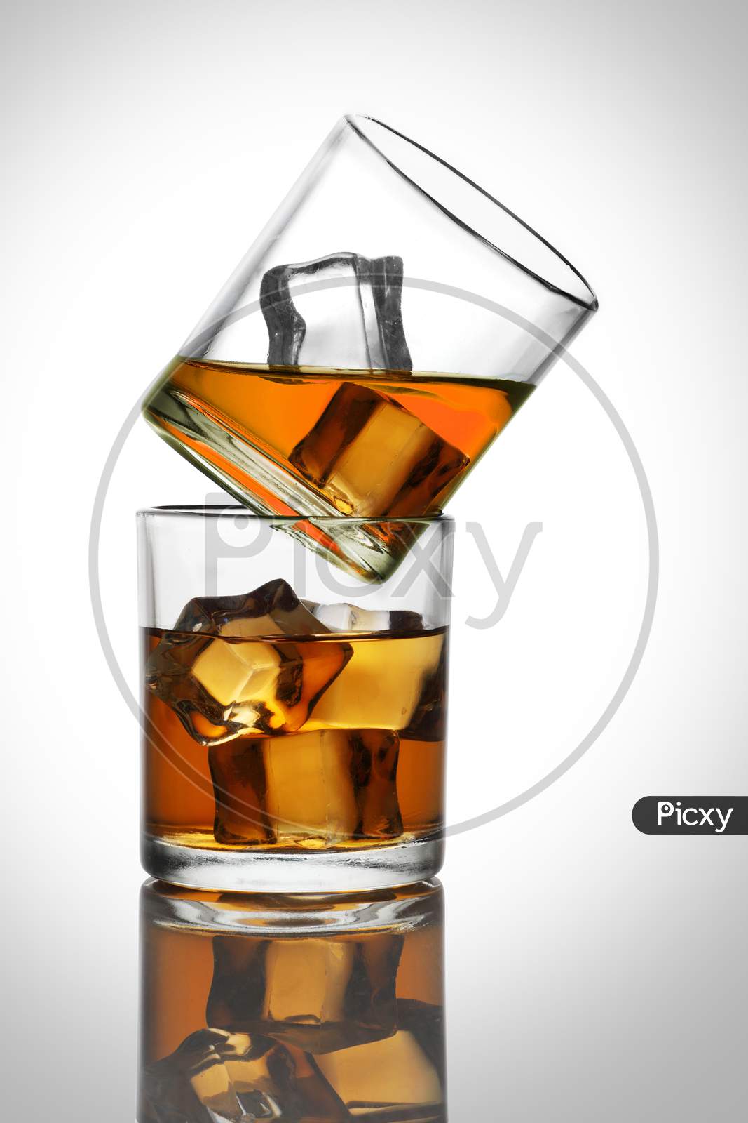 Two Glasses With Whiskey / Rum Drinks With Ice Cubes
