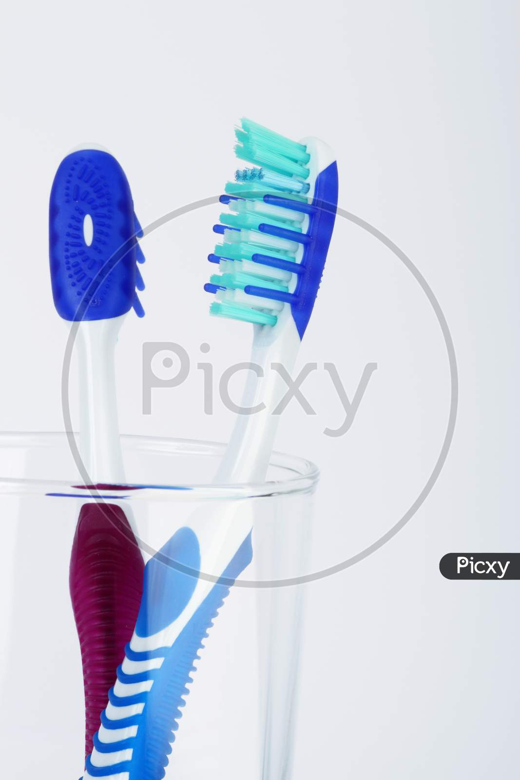 Two Tooth Brush In A Transparent Container
