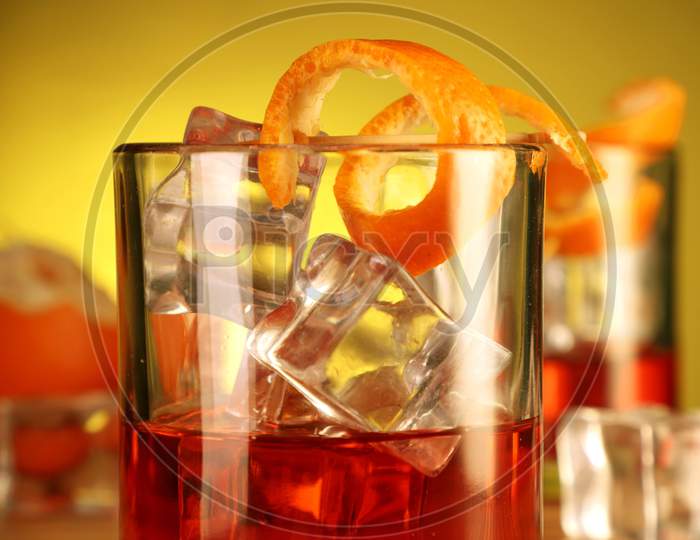 Chilled Alcohol Drink With Ice Cube And Orange Peel