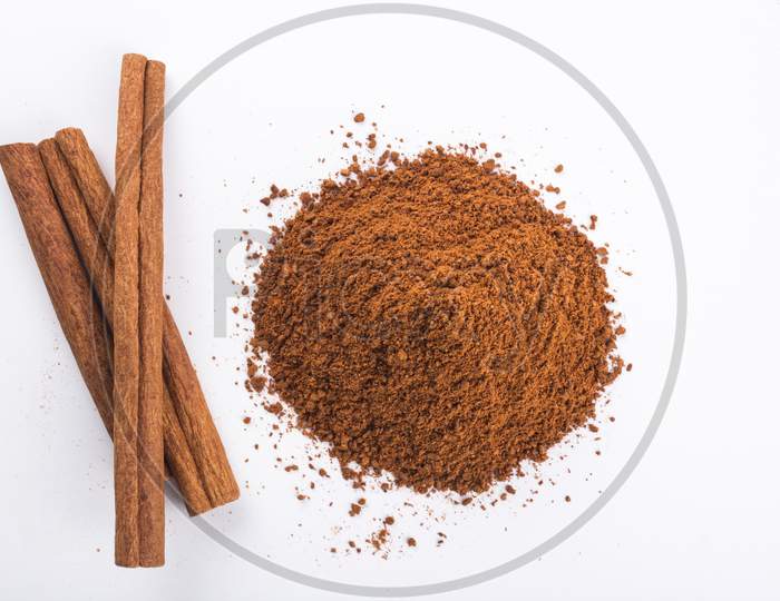 Cinnamon Sticks And Powder, White Background From Top Stock Photo