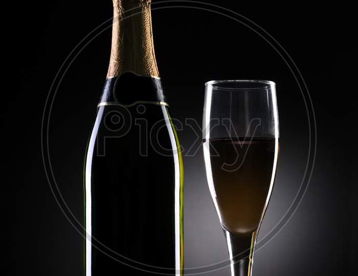 Champagne Bottle And Glass On Black Background