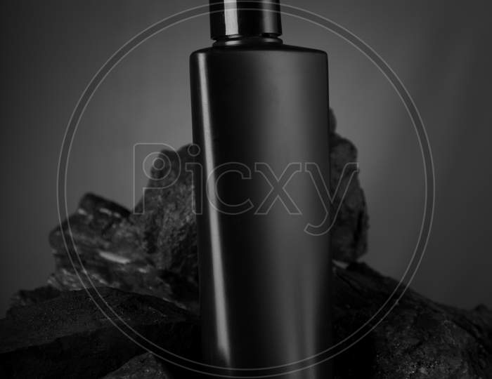 Black Blank Product Bottle On Black Stone For Mockups