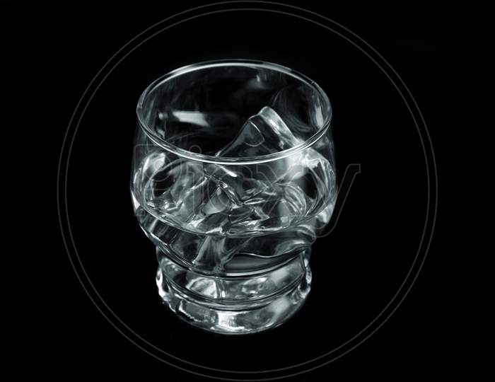Chilled Water With Ice Cubes On Black Background