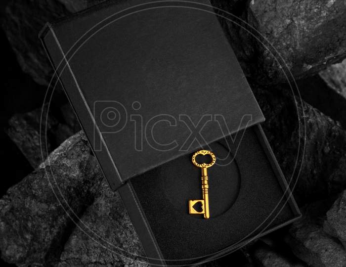 Golden Antique Key In A Black Box - Success Concept