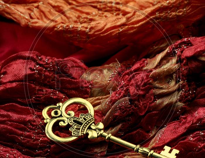 Antique Golden Key On Red Fabric