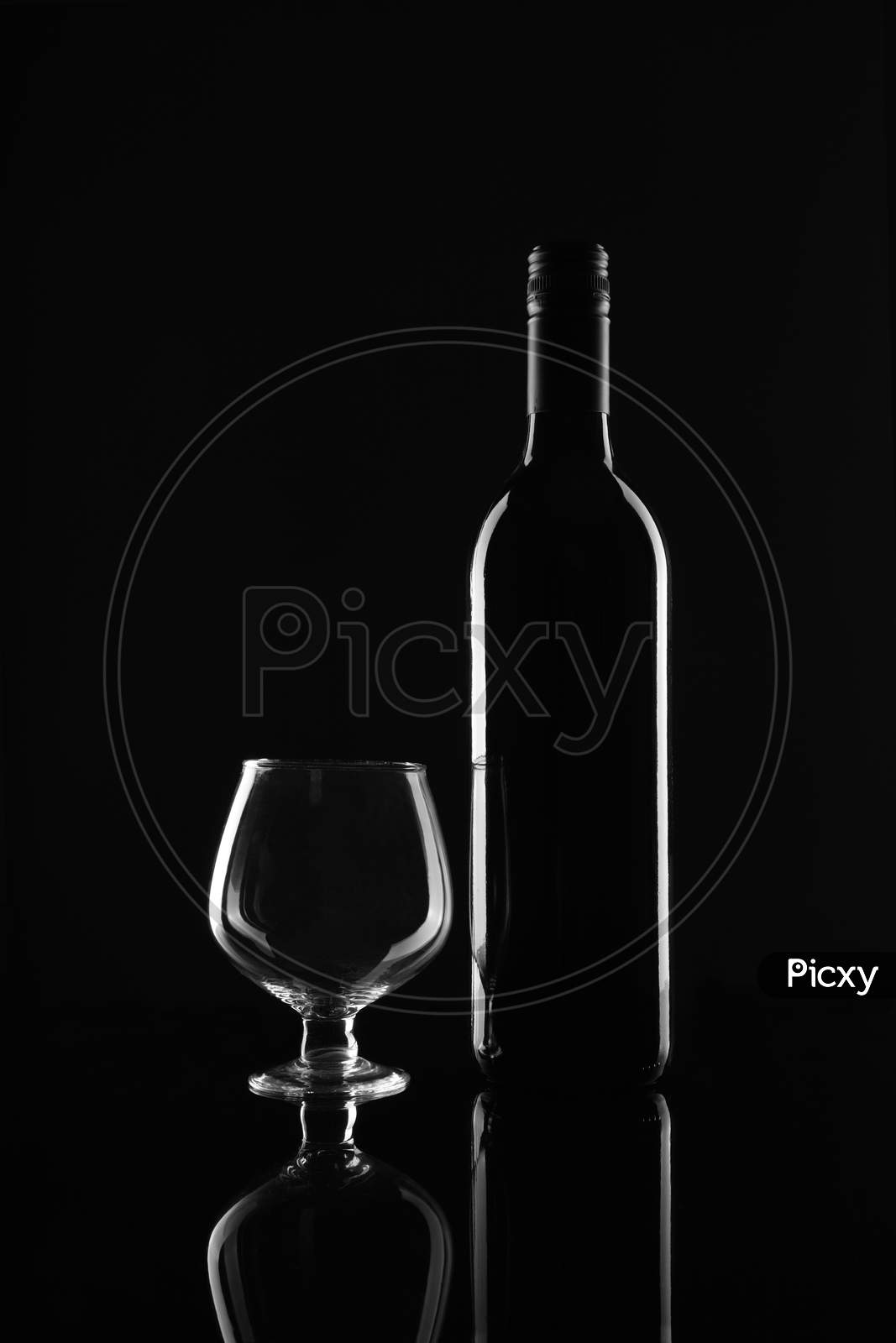 Red Wine Bottle And Glass On Black Background