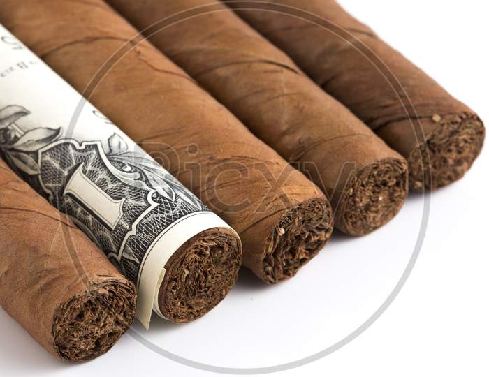 Cuban Cigar On A Several Dollar Bills On The Table Stock Photo