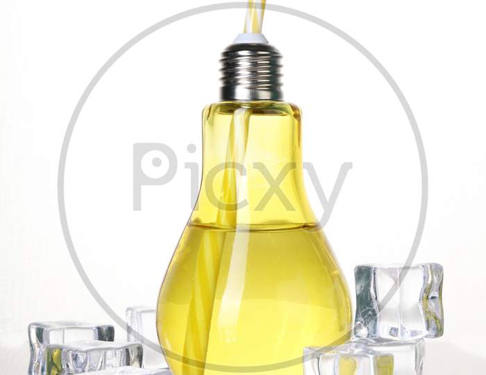 Bulb Shaped Drinking Glass In Yellow With Ice Cubes On White Background