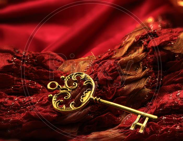 Antique Golden Key On Red Fabric Background