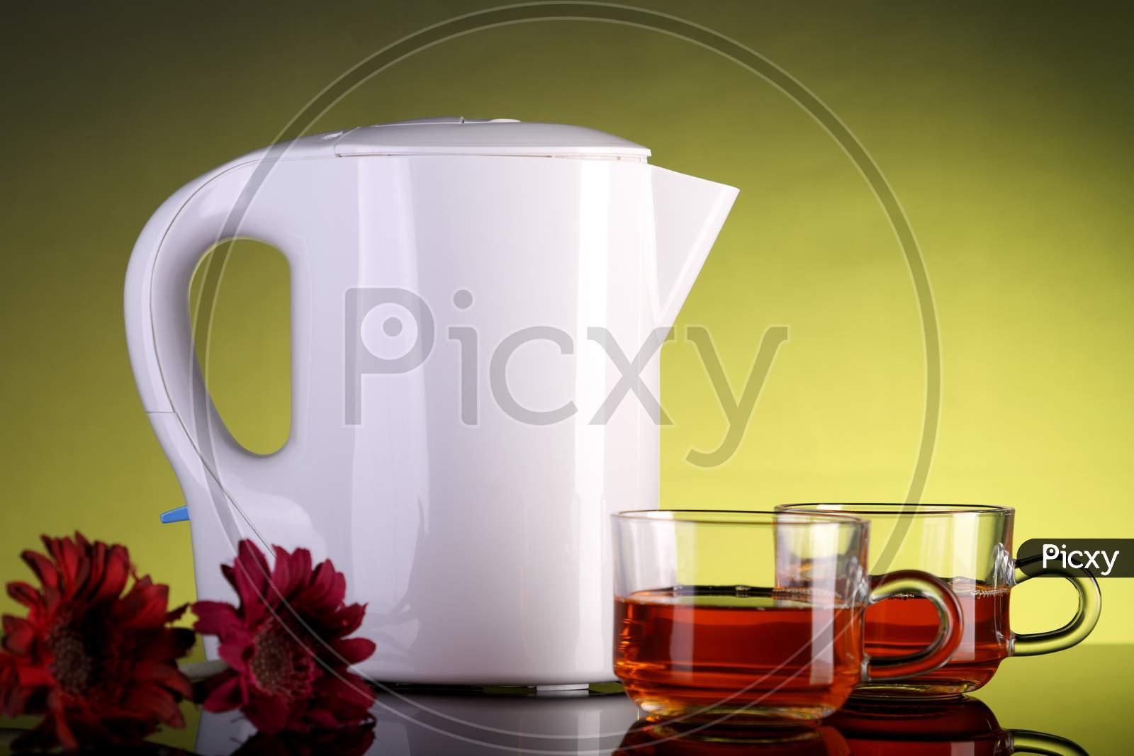 Electric Kettle And Two Tea Cups With Flowers