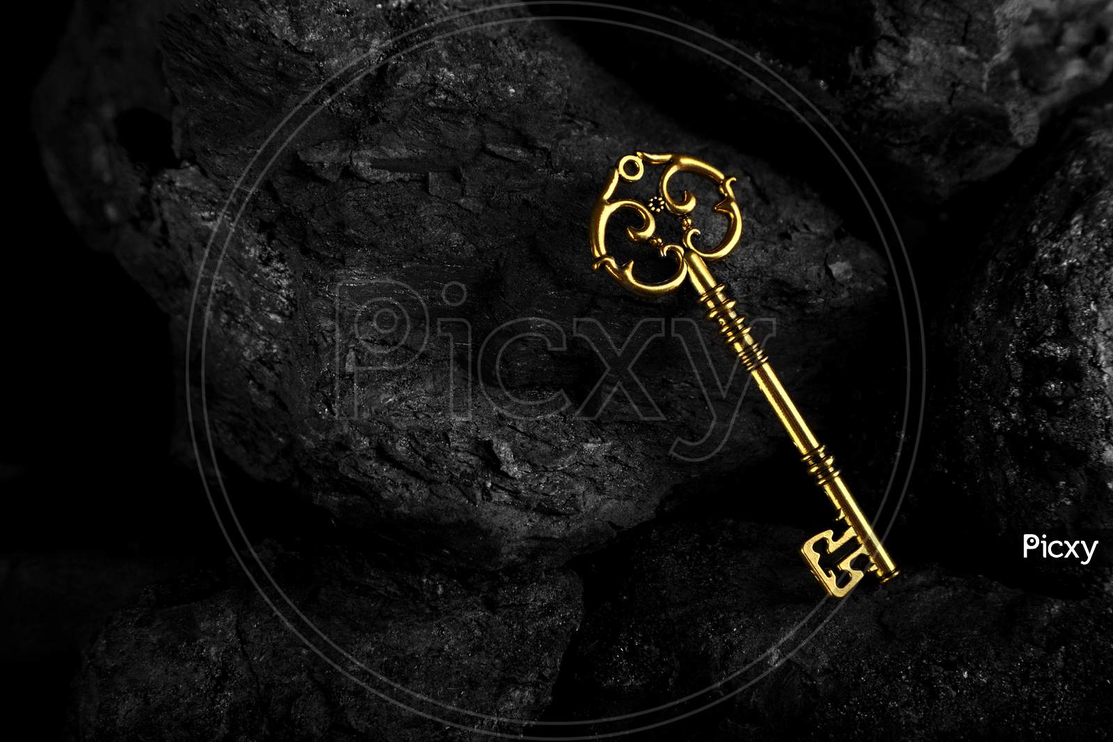 Golden Antique Key On Black Stone Background