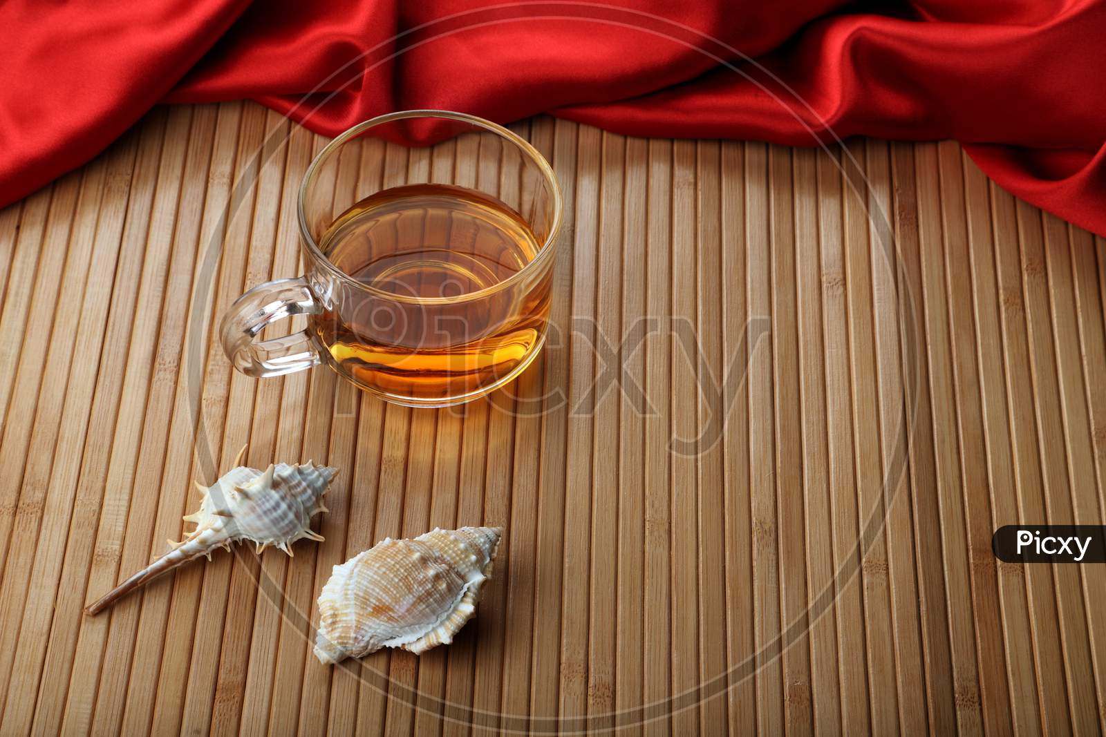 Cup Of Tea On Wooden Table Mat With Sea Shells