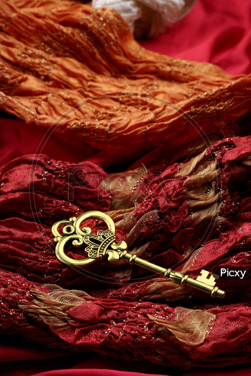 Antique Golden Key On Red Fabric