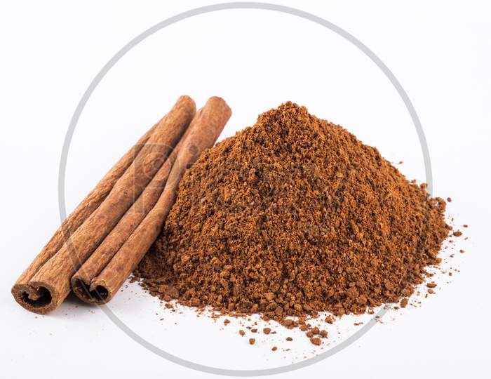 Cinnamon Sticks And Powder, White Background Stock Photo