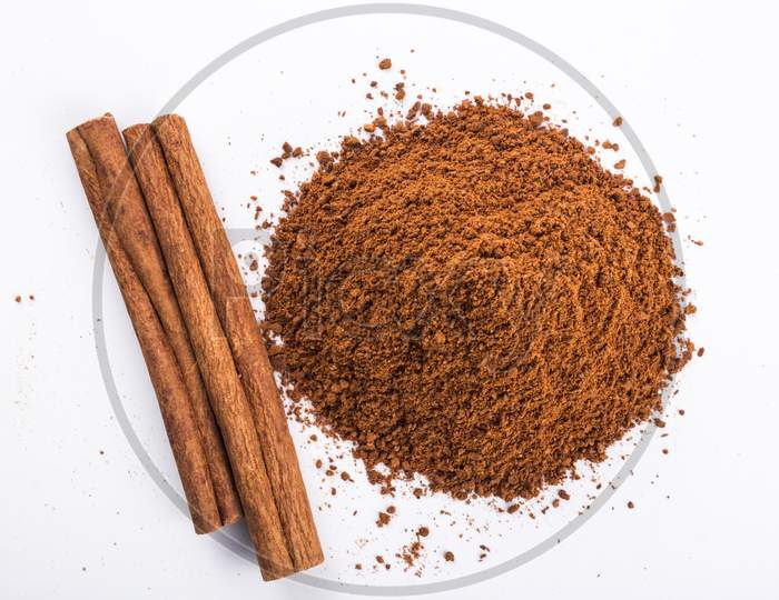 Cinnamon Sticks And Powder, White Background From Top Stock Photo