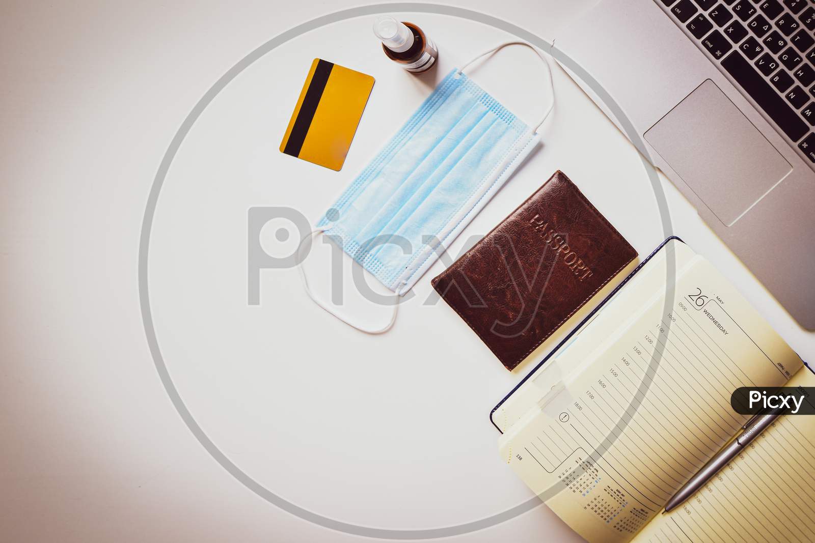 Mock Up Display Pandemic Travel Planning Concept. Laptop White Table Summer Holiday Vacation Background Concept. Flat Lay Top View Open Calendar Notebook, Laptop, Passport, Bank Card, Disinfectant Bottle, Accessories With Copy Space Background