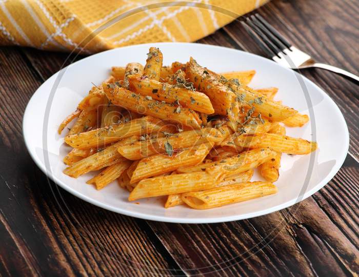 Food - Tasty Penne Pasta Plate With A Fork On Wooden Table