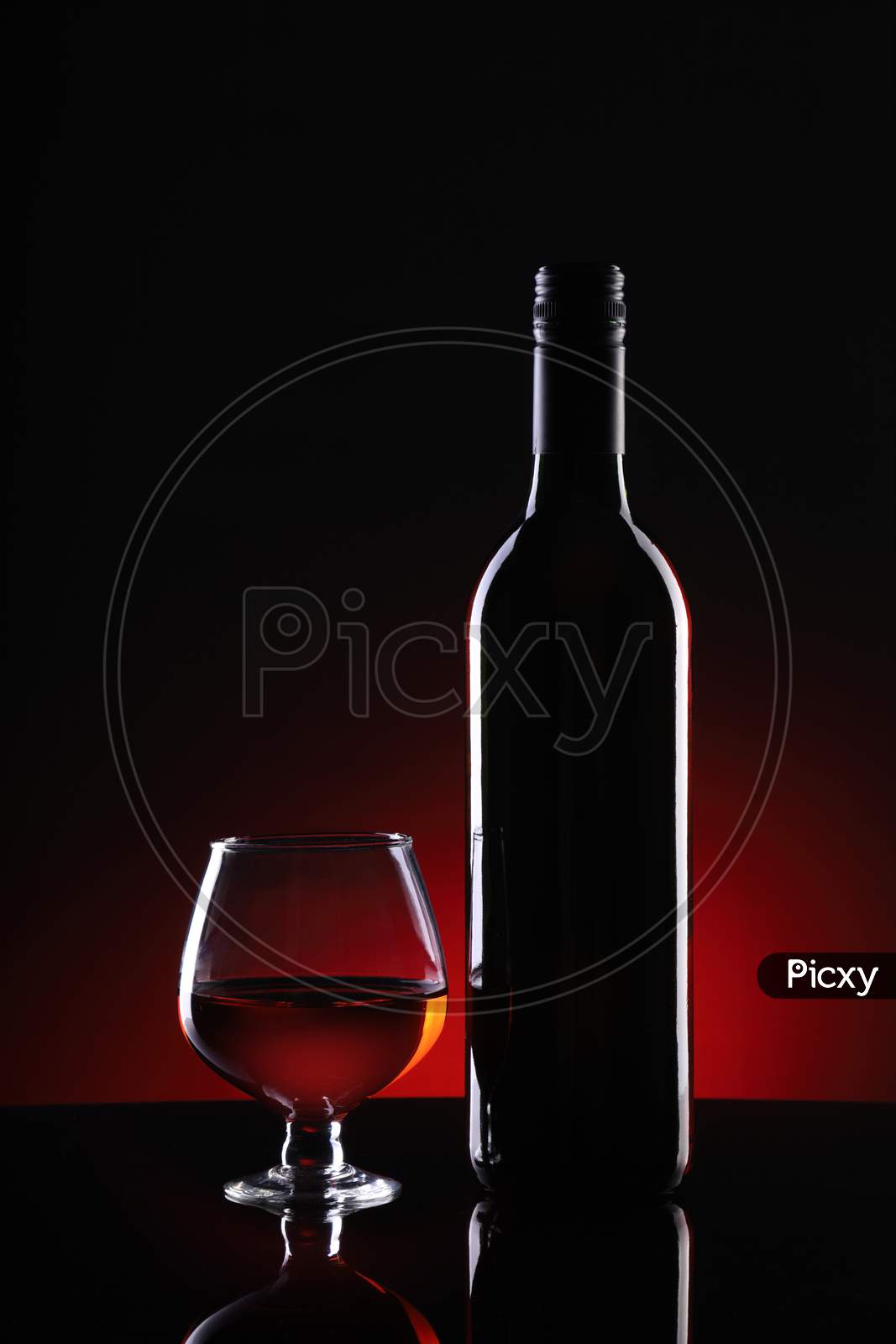 Red Wine Bottle And Glass On Dark Background