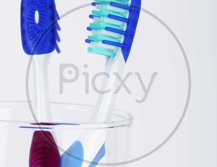 Two Tooth Brush In A Transparent Container