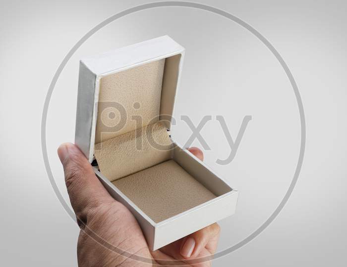 Empty Open White Jewelry Ring Box In A Hand