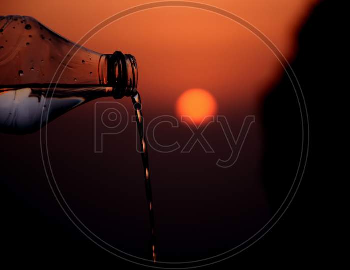 Beautiful Picture Of Water Is Coming Out From Bottle. Sunset In Background , Selective Focus On Subject , Selective Focus On Subject.