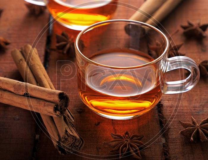 Healthy Herbal Tea With Star Anise And Cinnamon In A Cup On Wooden Table