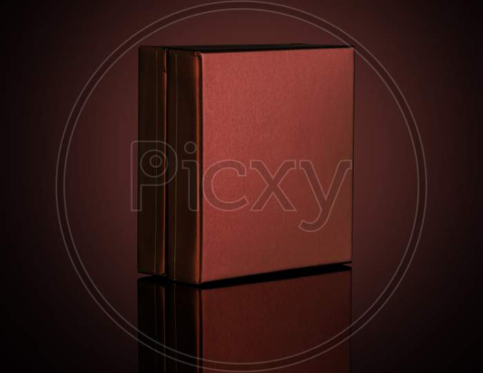 Brown Box For Mockups Isolated On Dark Background