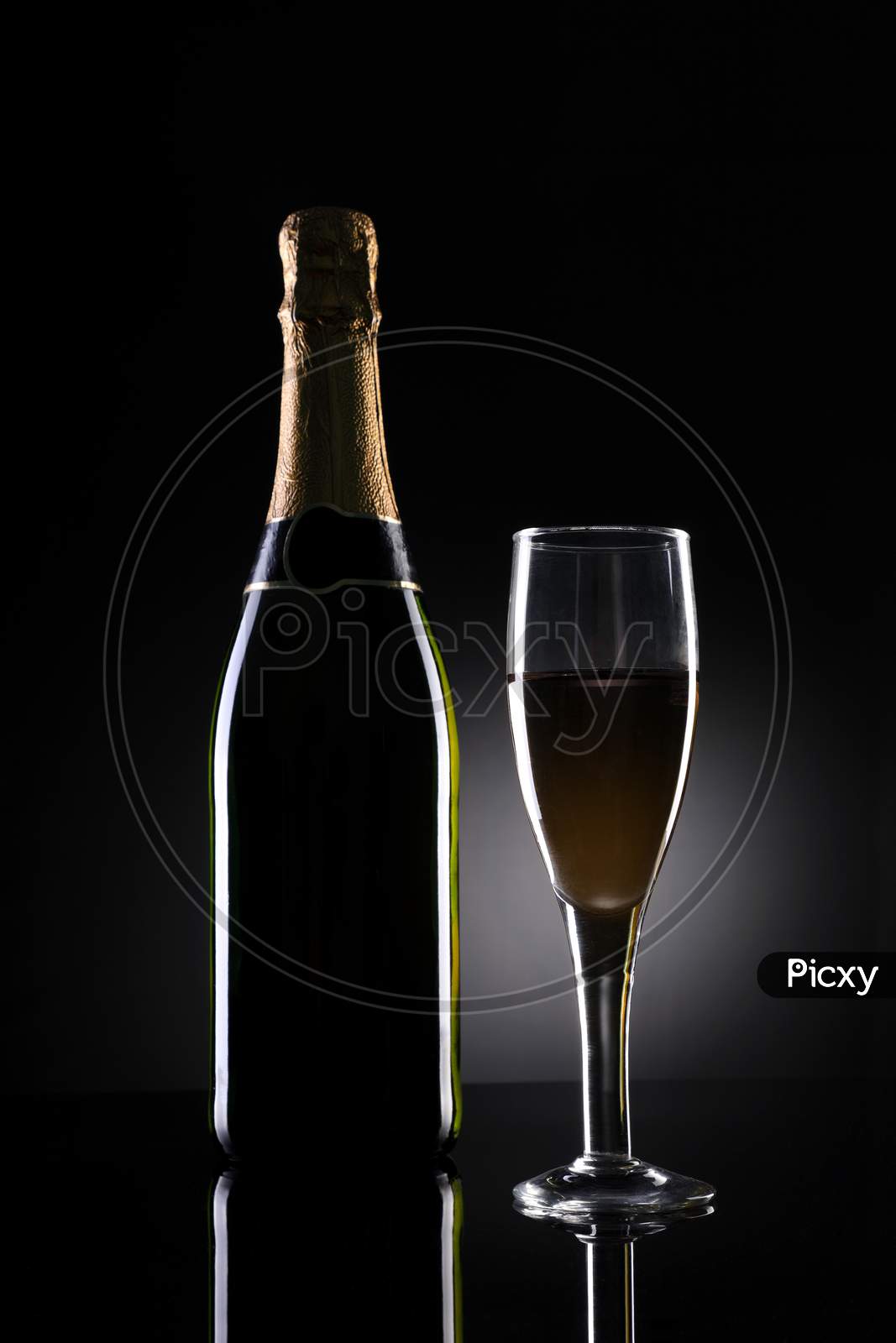 Champagne Bottle And Glass On Black Background